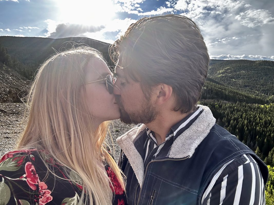 Thomas and Mary Catherine kissing in the Colorado mountains